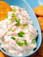 Sour Cream Onion Dip with green onions on top in a blue dish