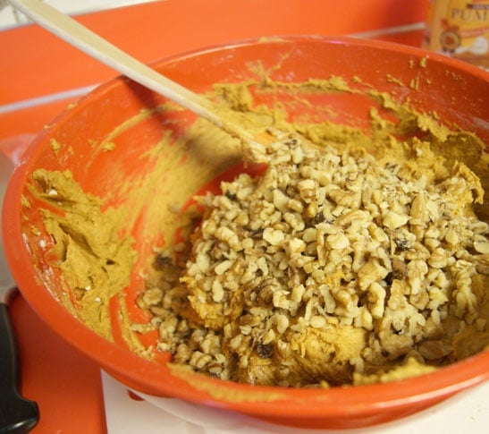 pumpkin muffin batter and walnuts in a red bowl
