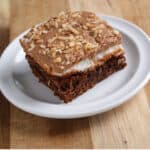 Mississippi mud brownie square on a white plate and wood board