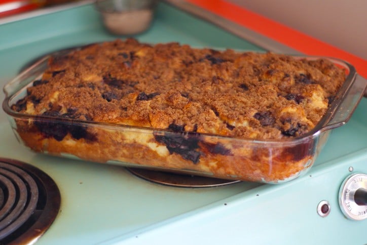 baked french toast casserole in glass dish on turquoise stove