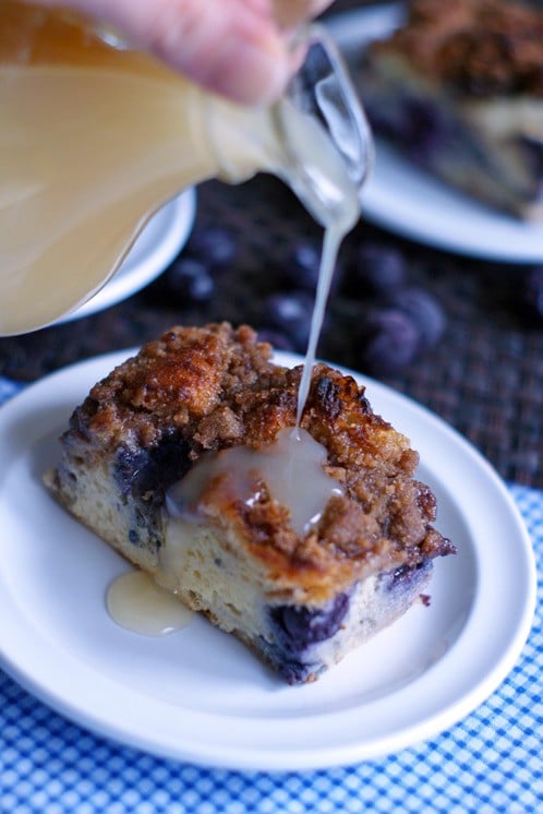 square of french toast casserole on white plate with buttermilk syrup