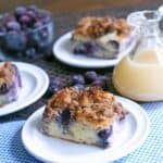 blueberry french toast casserole on white plate with blue check napkin