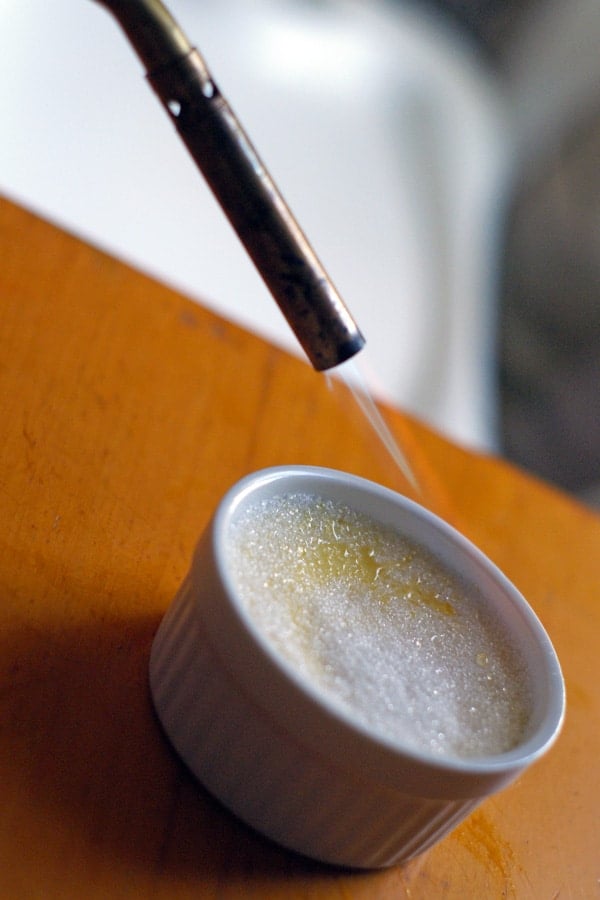 close up of torch melting sugar