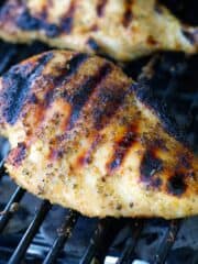 Seasoned grilled chicken breast on the grill