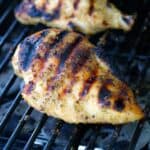 seasoned grilled chicken breast on the grill