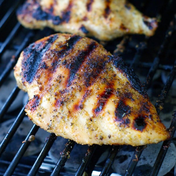 Seasoned chicken breast on grill