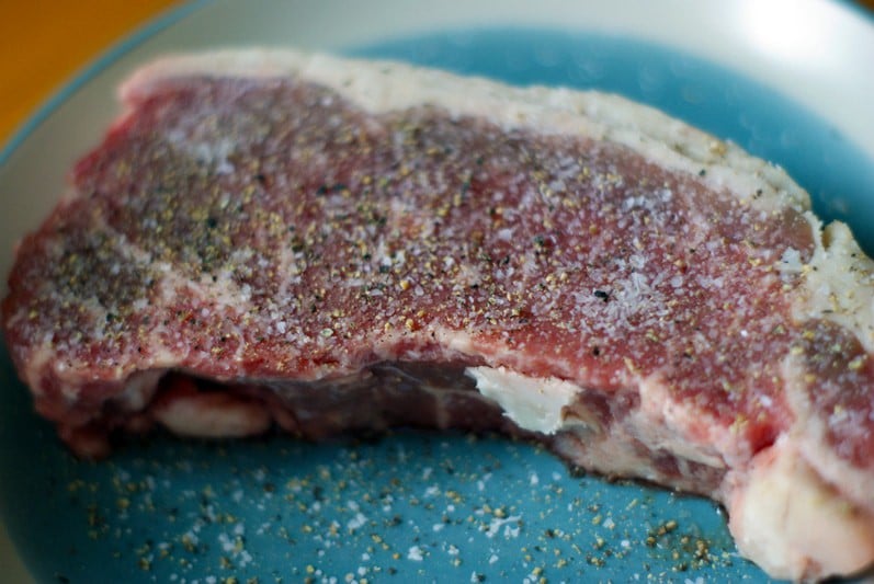 seasoned steak on a blue plate
