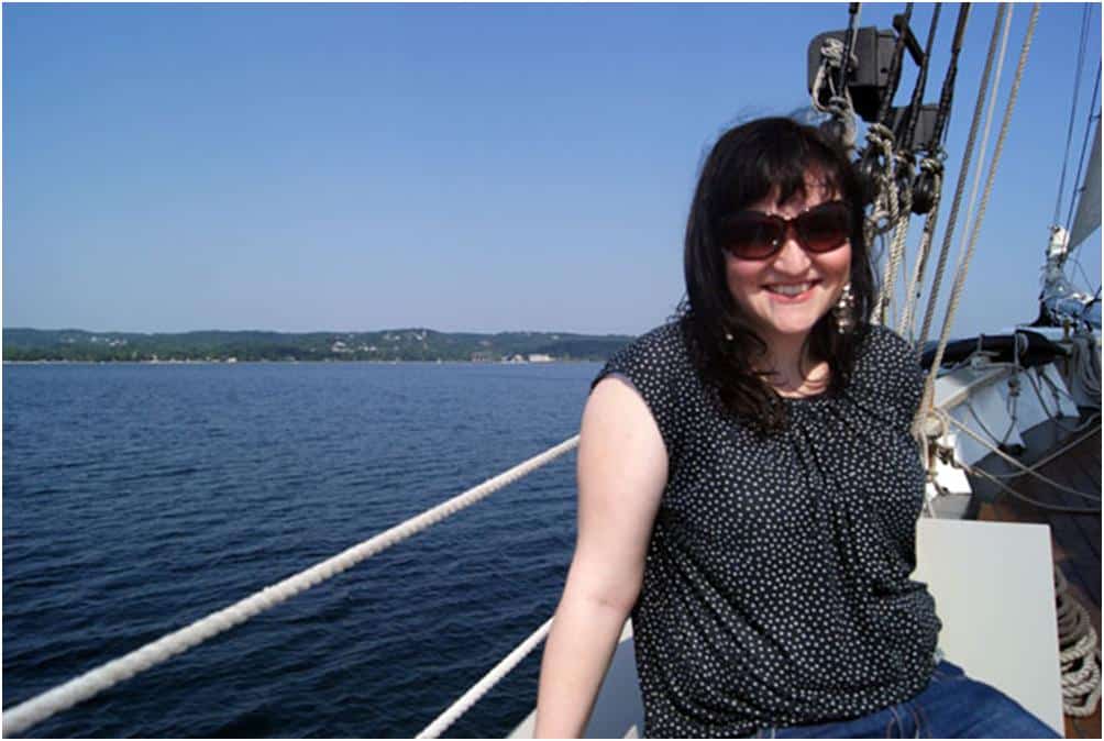 Heather sitting on the side of a boat