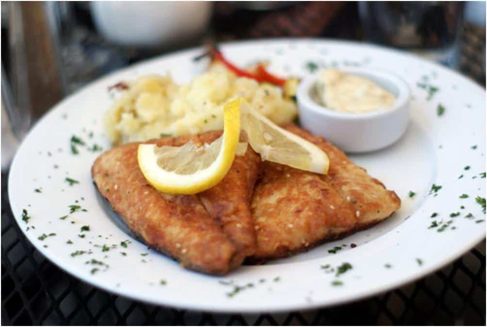 fried white fish on a white plate