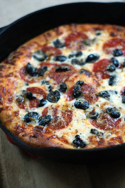 baked deep dish pizza in a cast iron pan