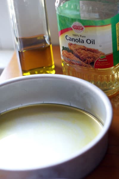 olive and canola oil in a cake pan 