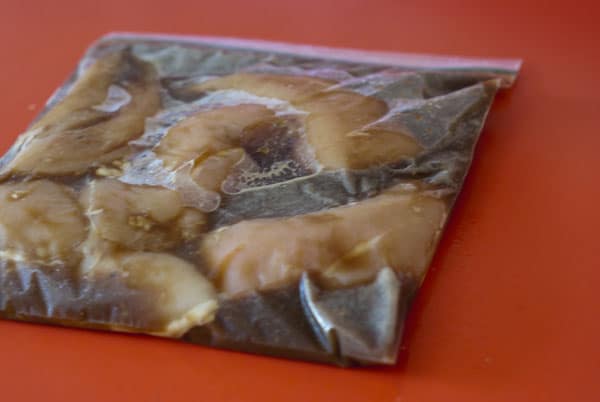 chicken breasts in marinade in a ziplock bag