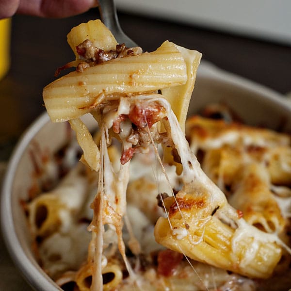 Pasta Al Forno on a fork over a baking dish