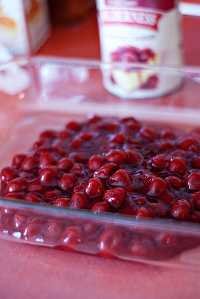 canned cherries in a glass baking dish