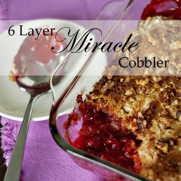 Cherry dump cake in a glass baking dish on a pink napkin