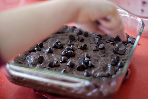 Chocolate Chips being put on Cake Mix Brownies
