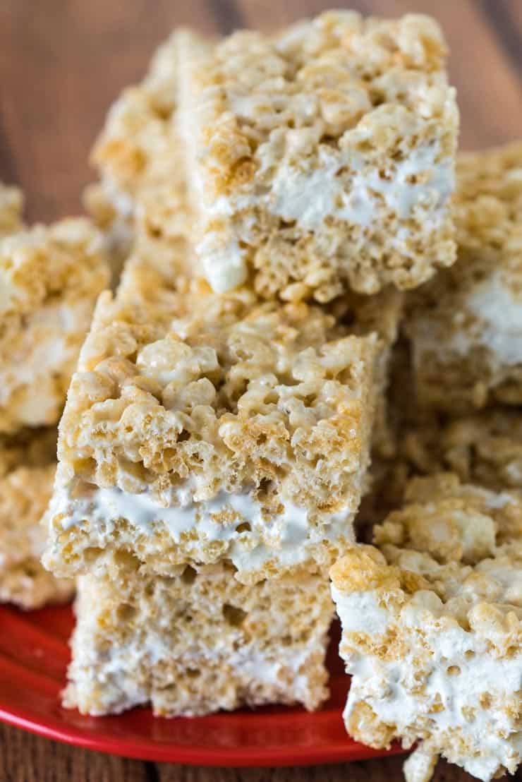 Rice Crispy treats with marshmallow cream on a red plate