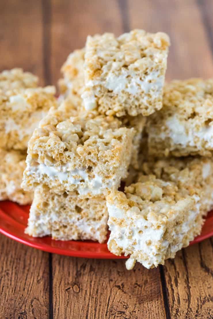 Rice crispy treat recipe with a fluff center on a red plate