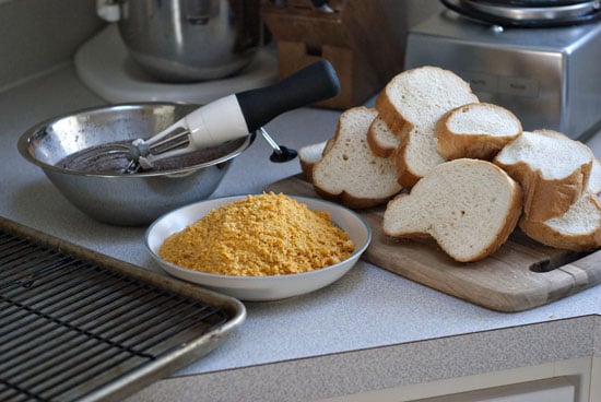 Bowl of french toast mix, cap'n crunch and bread on a table.