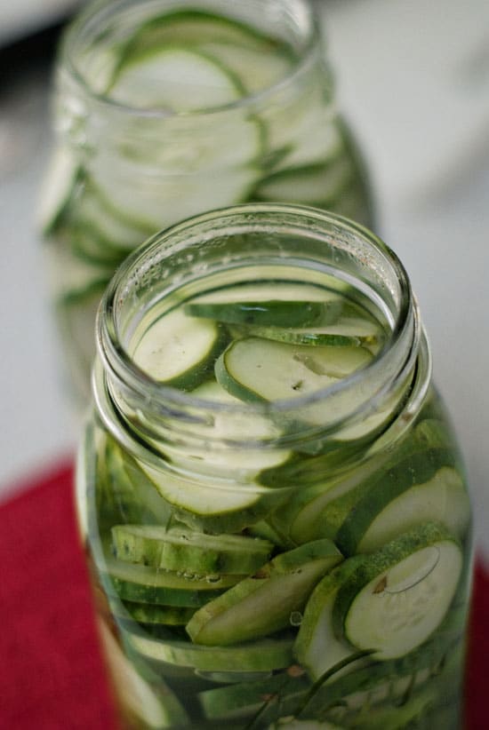 Simple pickles recipe in two glass mason jars.
