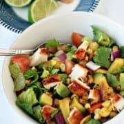 Simple BBQ Chicken Chopped Salad recipe in a large white bowl with a silver fork.