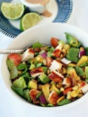 Simple BBQ Chicken Chopped Salad recipe in a large white bowl with a silver fork.