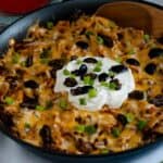 From scratch Beef Enchilada Skillet topped with fresh olives and green onions.