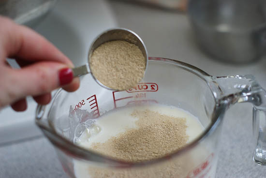 Warm milk, eggs and yeast in a glass measuring cup.