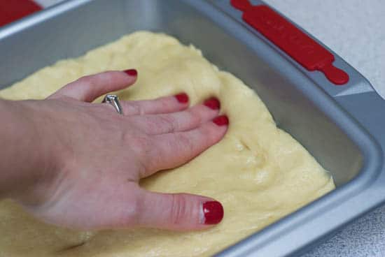 Pressing Cake dough in a cake boxx cake pan.