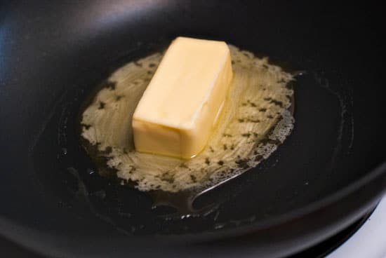 Butter melting on a large skillet.
