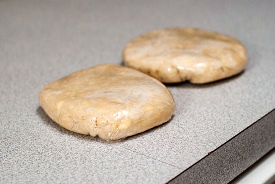 Secret Ingredient Pie Crust balls made into circles on a table.