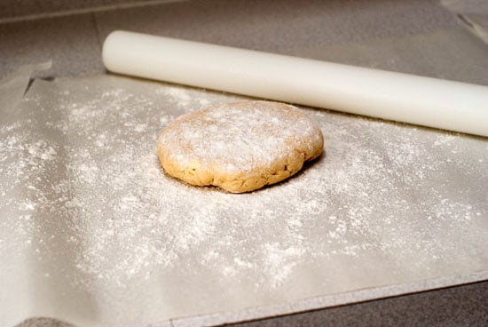 Chilled pie dough on floured parchment paper.