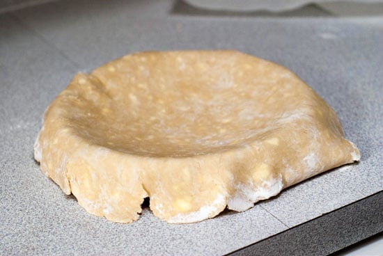 No Fail pie crust dough on top of pie dish on a table.