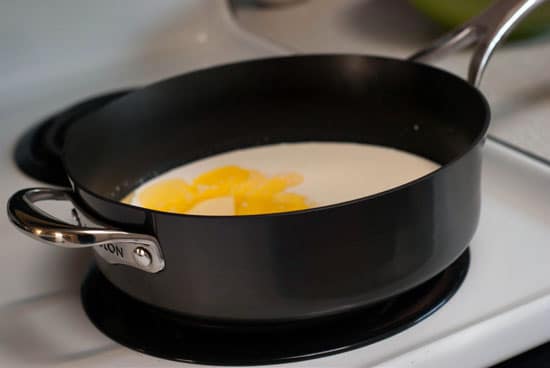 Cream, butter and garlic in a large black skillet.