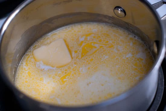 Cream and butter mixture in a silver saucepan.