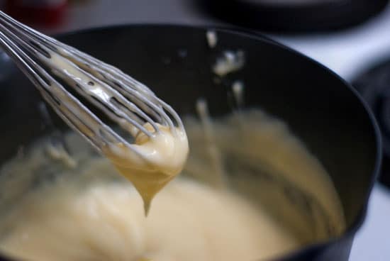 Delicious custard on a silver whisk.