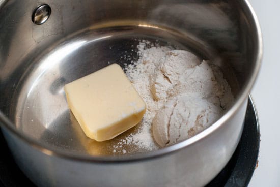 Butter and flour in a silver mixing bowl.