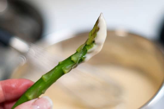 Fresh Asparagus dipped in homemade Cheese Sauce.