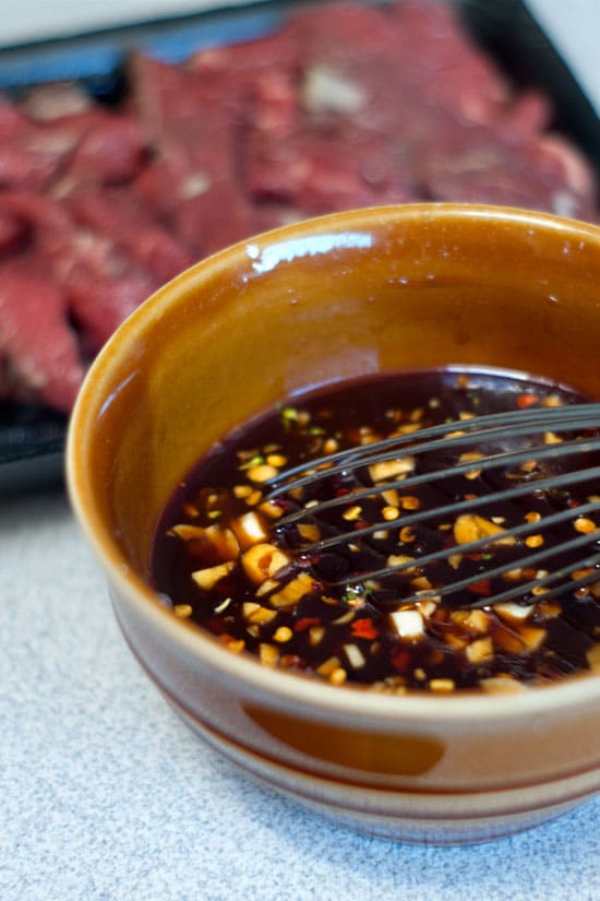 Homemade Teriyaki Sauce in a small bowl with a whisk.