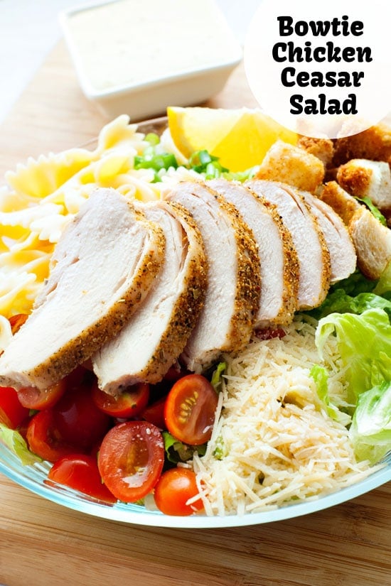 Simple Bowtie Chicken Caesar Salad with fresh Parmesan, tomatoes and croutons.