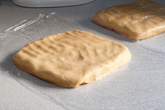 Delicious sugar cookie dough squares in clear plastic wrap.