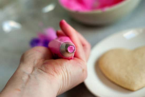 Pink icing in a round decorating tip.