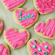 Valentine's Day sour cream sugar cookies with pink icing on a table.