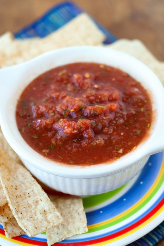 Restaurant Style Salsa in a small white bowl surrounded by tortilla chips.