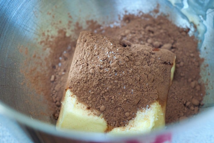 Chocolate cake mix with butter in a silver mixing bowl.