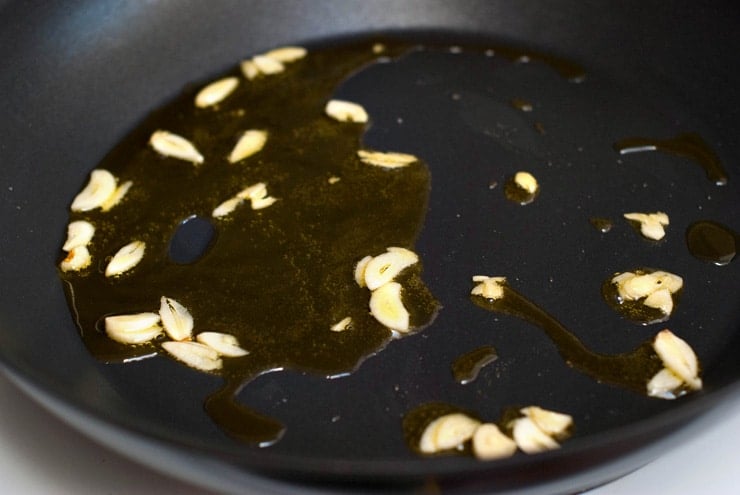Roasting Garlic and oil in a black skillet.