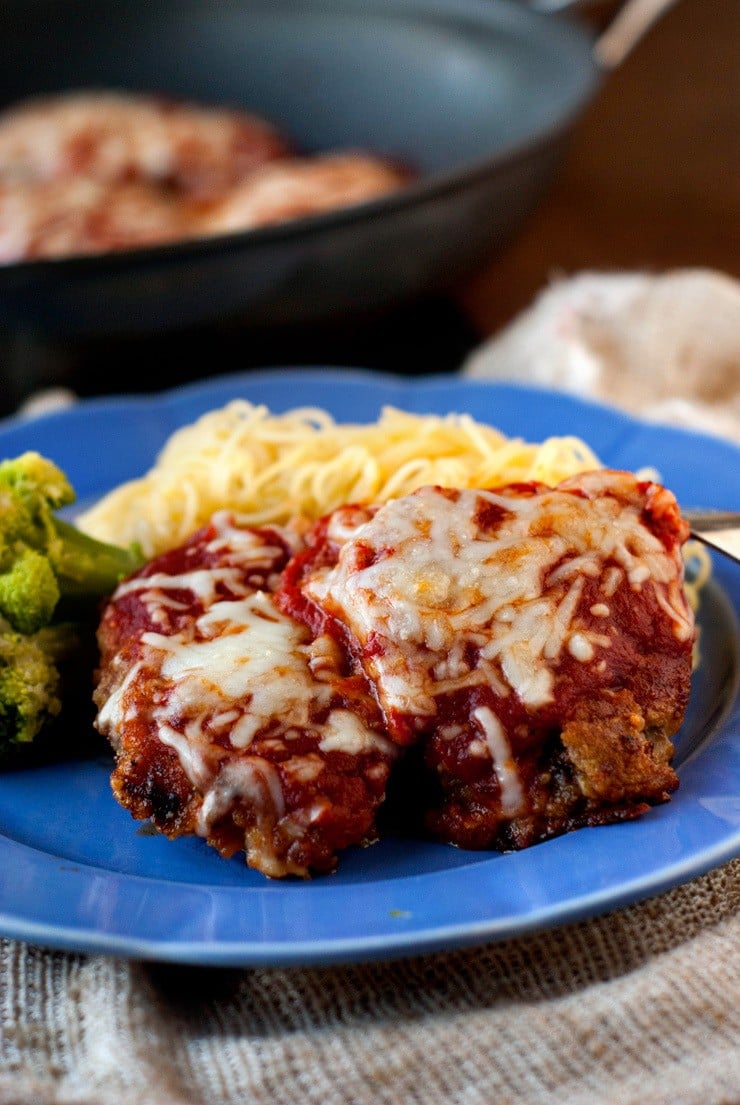 Easy Beef Parmesan with Garlic Parmesan Pasta and broccoli on a blue serving plate.