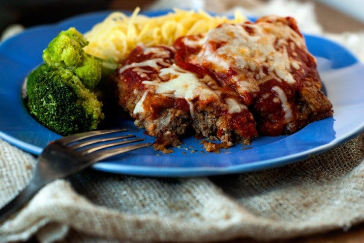 Simple Beef Parmesan with broccoli and spaghetti on a blue plate with a silver fork.