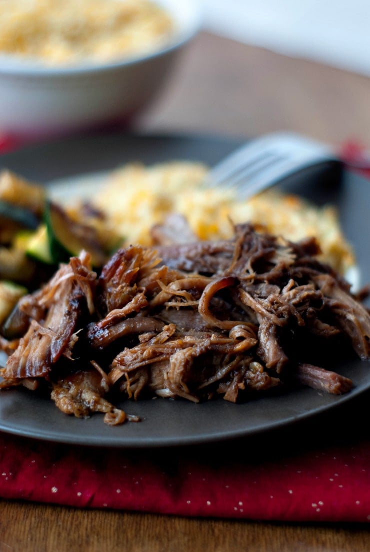 Slow Cooker Blackberry BBQ Pulled Pork on a black plate.