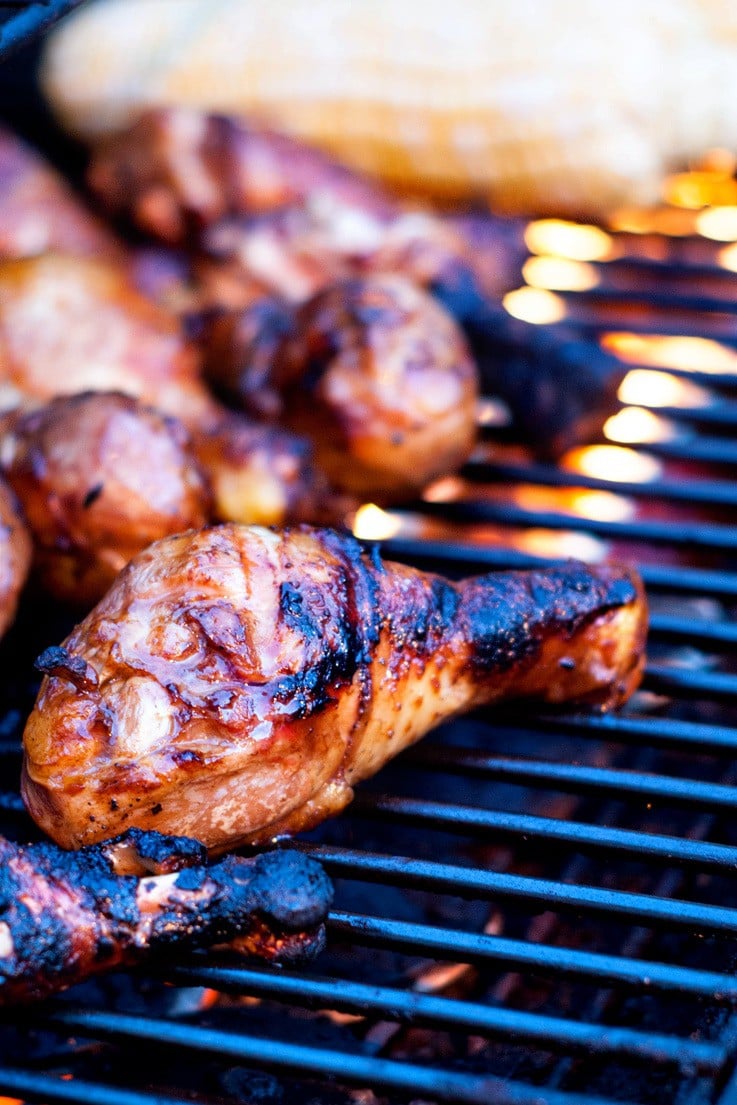 Grilling chicken wings and drumsticks on a grill.